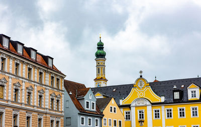 Low angle view of building against cloudy sky