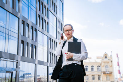 Successful businesswoman or manager, woman talking on mobile phone while