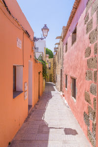 Cobblestone street amidst buildings against sky