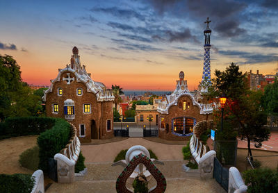 Park guell in city against sky during sunset