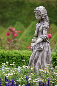 Statue of angel on field