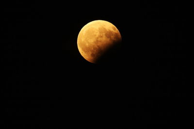 Low angle view of half moon against clear sky at night