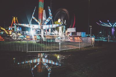 Illuminated ferris wheel at night