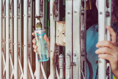 Midsection of woman holding bottle