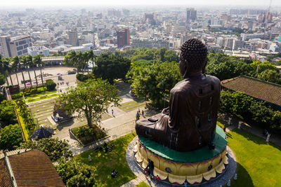 High angle view of statue against buildings in city