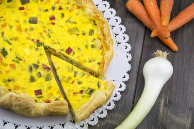 High angle view of yellow tart on table