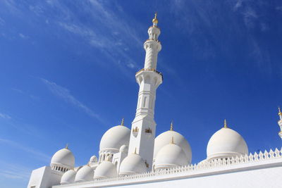 Low angle view of a mosque against blue sky