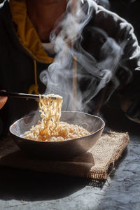 Close-up of person eating noodles