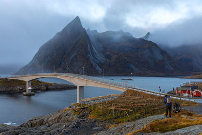 Bridge over river against mountains