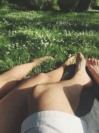 Low section of woman relaxing on grass