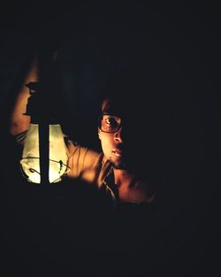 Young woman in dark room