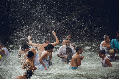 Group of people walking on wet floor