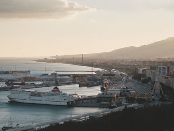 High angle view of townscape by sea against sky