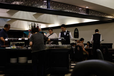 Group of people working in kitchen