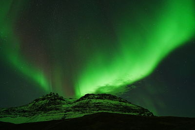 Scenic view of snowcapped mountains against sky at night
