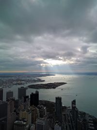 Aerial view of city against cloudy sky