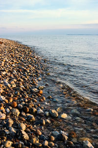 View of pebbles on beach against sky