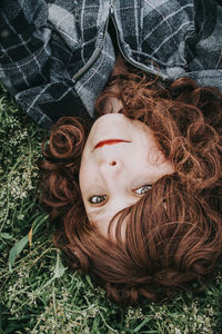 Directly above shot of woman lying on plants