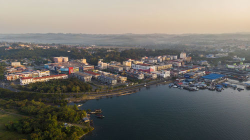 High angle view of townscape by river against sky