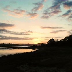 Scenic view of lake at sunset