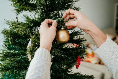 Close-up of woman holding christmas tree