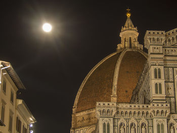 Low angle view of illuminated building against sky at night