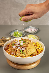 Midsection of person preparing food in bowl