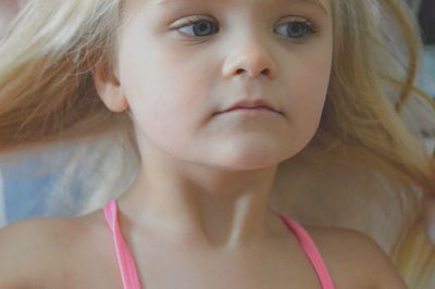 Close-up of cute girl looking away