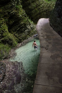 High angle view of man surfing on rock by river