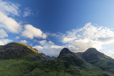 Scenic view of mountains against cloudy sky