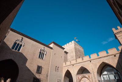 Low angle view of building against clear blue sky