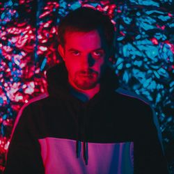 Portrait of young man standing at night