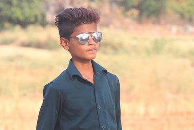 Portrait of teenage boy wearing sunglasses looking away