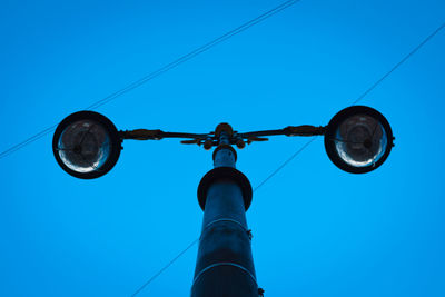 Low angle view of street light against clear blue sky