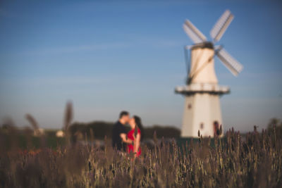 Loving couple between the lavender plantation and the windmill