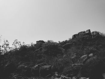 Low angle view of rocks against clear sky