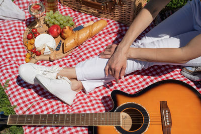 Midsection of man playing guitar