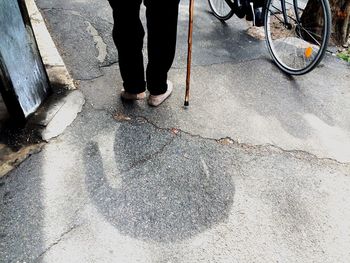 Low section of people walking on sidewalk