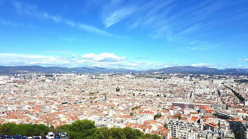 High angle view of town against blue sky