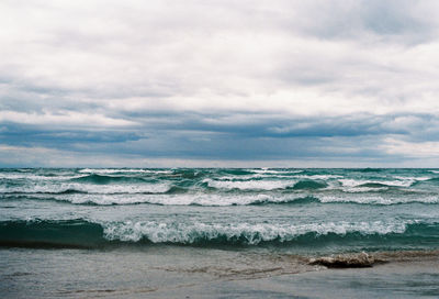 Scenic view of sea waves against sky