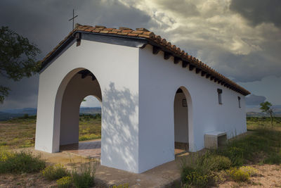 Built structure on field against sky