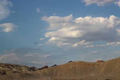 Scenic view of clouds over mountains against sky