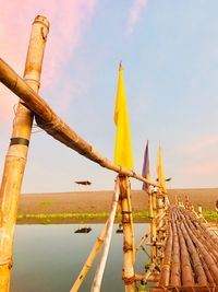 Bamboo footbridge against sky 