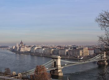 Bridge over river with city in background