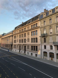 Road by building against sky in city