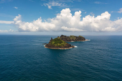 Rocky tropical island in the blue ocean. dos hermanos island. santa ana, cagayan. philippines.