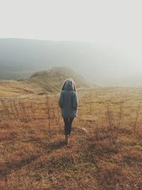 Man standing on mountain against sky