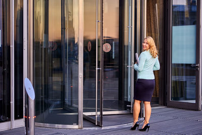 Woman standing by window