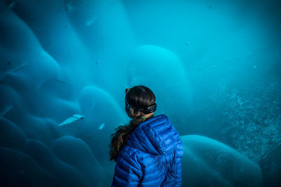 Rear view of woman underwater