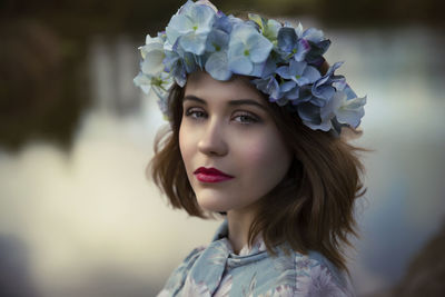 Portrait of woman holding flower